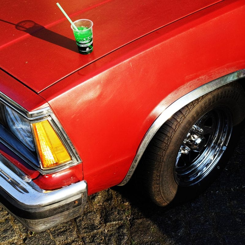 red car street photography, colorful, by Manuel Armenis