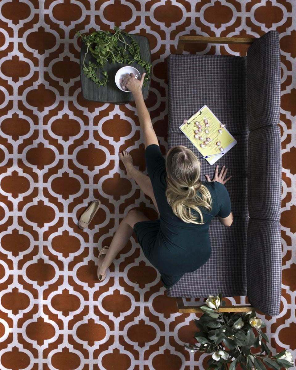 woman on couch color photography of patterns from above by Hayley Eichenbaum and Zach Swearingen