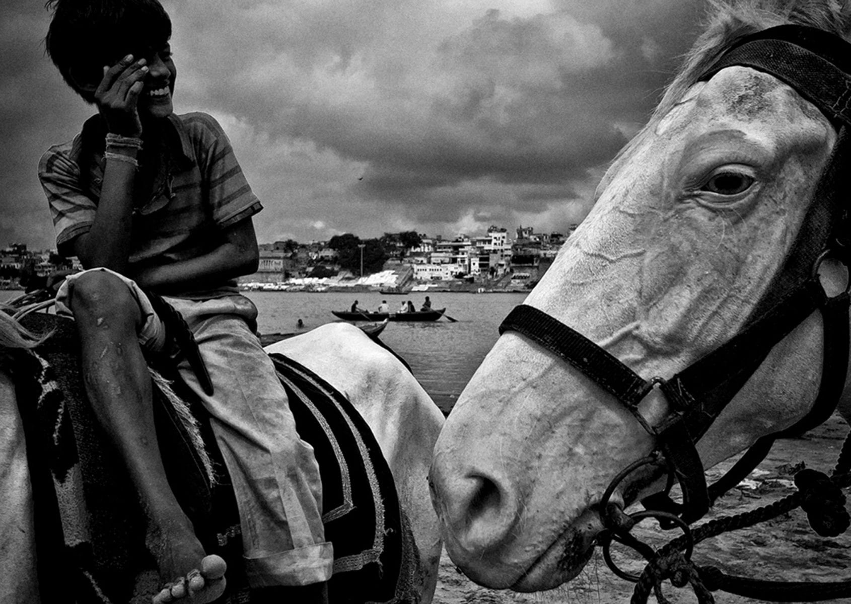 kid sitting on a horse, black and white street photography by swarat ghosh