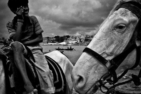 kid sitting on a horse, black and white street photography by swarat ghosh