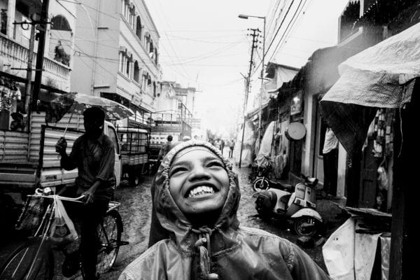 kid smiling, black and white portrait street photography by swarat ghosh