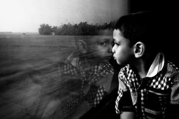 kid in train street photography by swarat ghosh