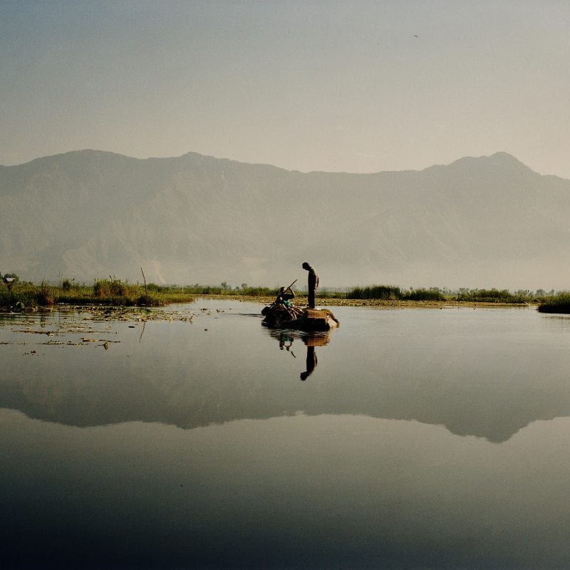 Travel photography portrait by Frédéric Lagrange. Man on a boat, Kashmir, India