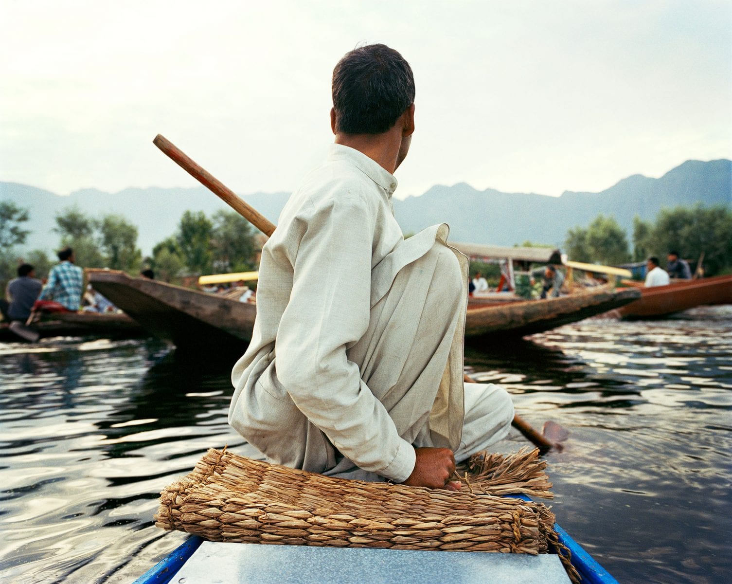 Travel photography portrait by Frédéric Lagrange. Man on a boat, Kashmir, India