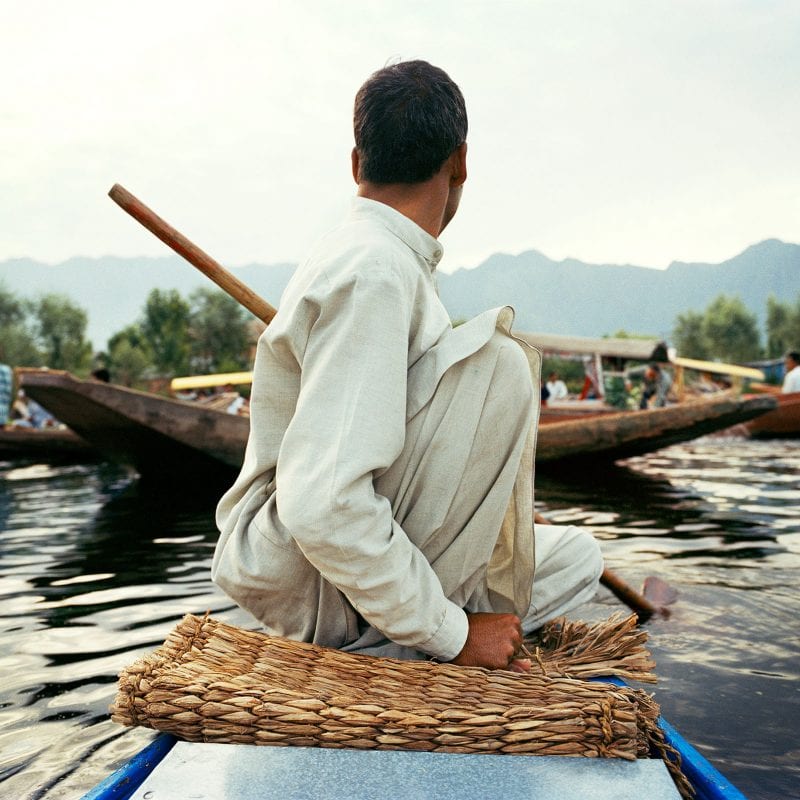 Travel photography portrait by Frédéric Lagrange. Man on a boat, Kashmir, India