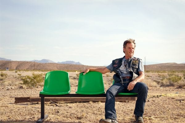 old man sitting on a green bench, color portrait photography by dylan collard