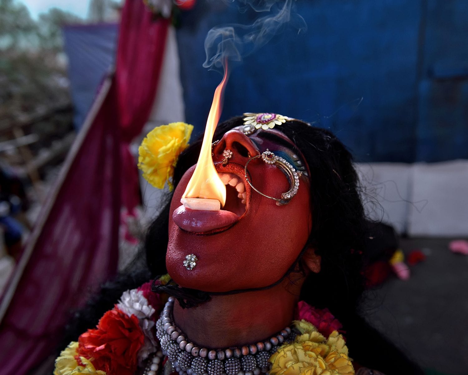 Travel image by Sudipta Dutta Chowdhury, depicting a man breathing fire in a Hindu Festival in India