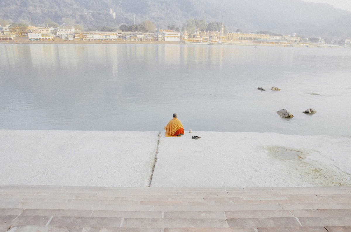 color travel photo of man by Ganges river in India by Debmalya Choudhuri