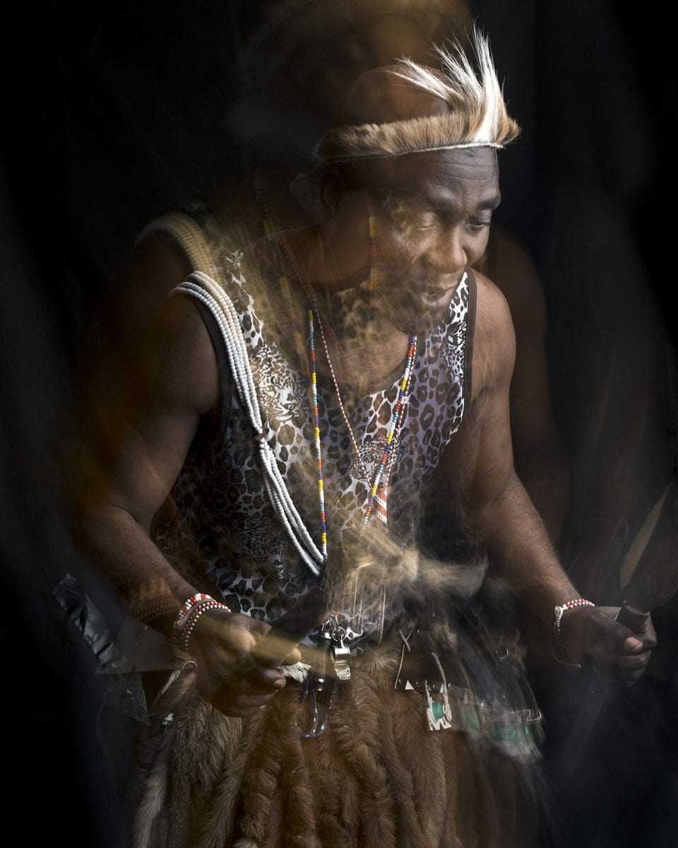 out of focus, blurry, colorful and very contrasted portrait of a healer from South Africa by Thom Pierce