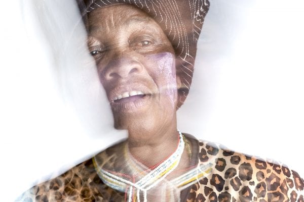 out of focus, blurry, colorful and very contrasted portrait of a healer from South Africa by Thom Pierce