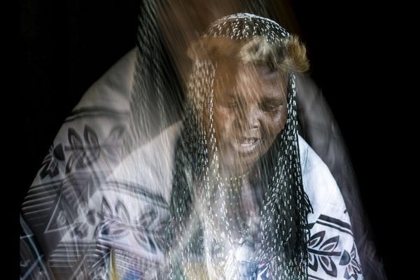 out of focus, blurry, colorful and very contrasted portrait of a healer from South Africa by Thom Pierce