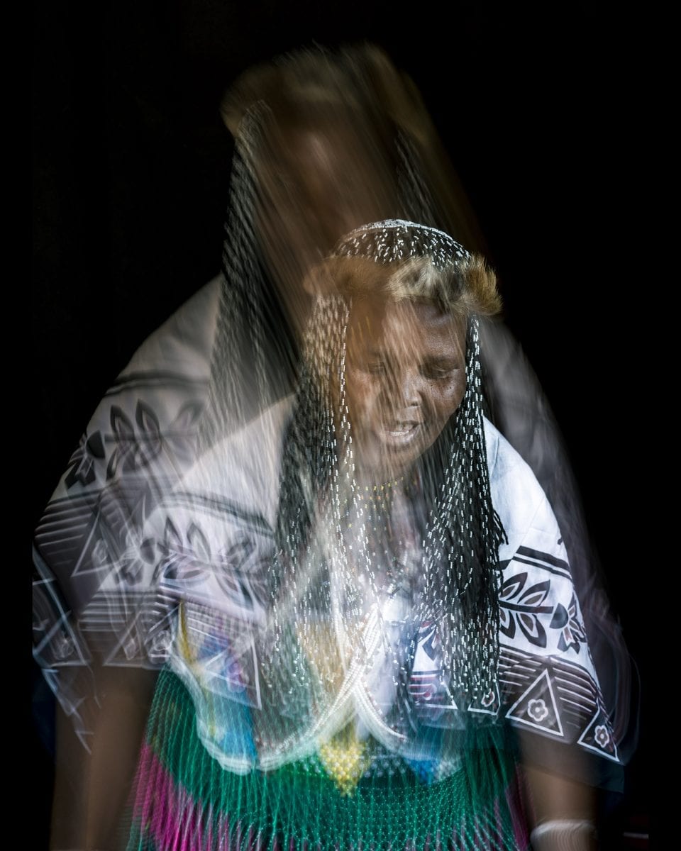 out of focus, blurry, colorful and very contrasted portrait of a healer from South Africa by Thom Pierce