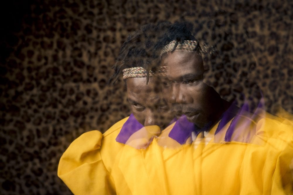 out of focus, blurry, colorful and very contrasted portrait of a healer from South Africa by Thom Pierce