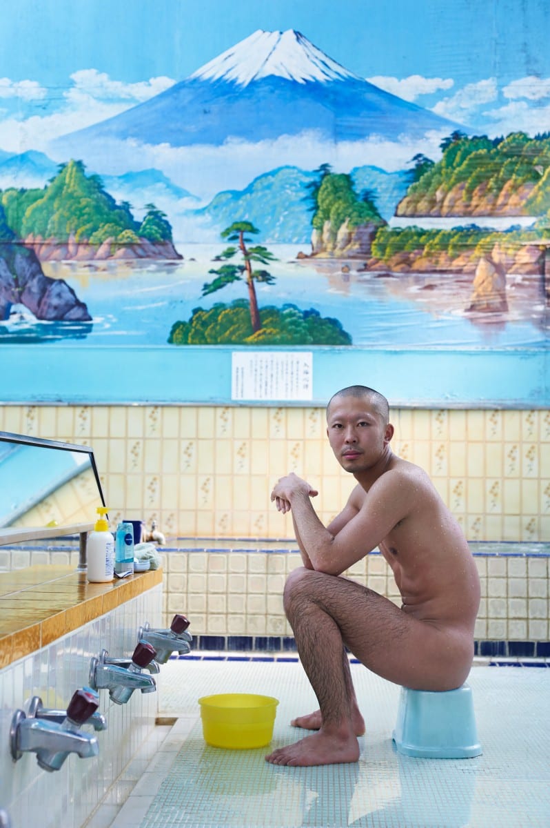 color portrait photograph of a Japanese man in sento bath house in tokyo, japan by Simon Urwin