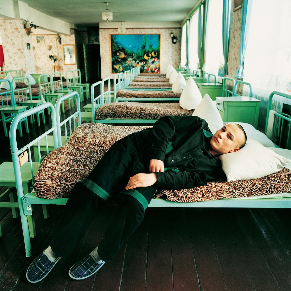 Portrait of a person lying on a bed photography by Michal Chelbin