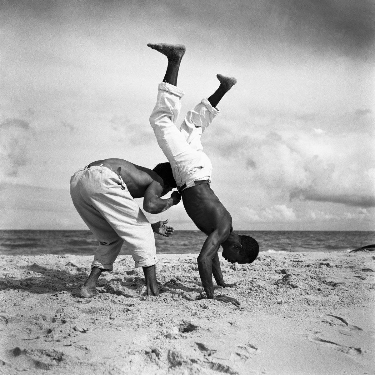 Black and white portrait of Brazilian men playing capoeira by Marcel Gautherot