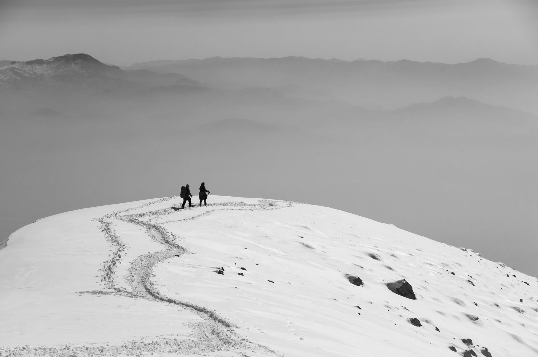 Black and White photo by Payam Hamzei of two women climbing Darabad Mountain, north of Tehran, Iran