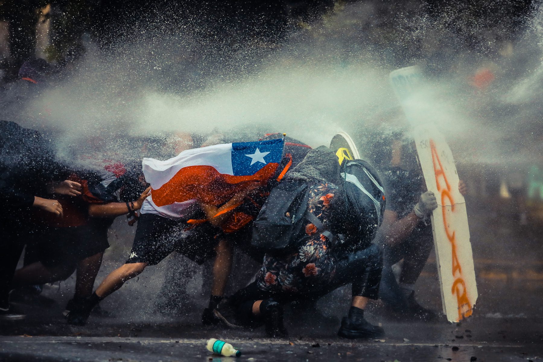 Color documentary photograph by Javier Vergara of Chilian protestors in Santiago, Chile, on November 11th, 2020