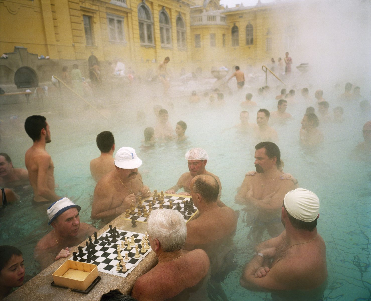 Color photo by Martin Parr men bathing and playing chess at Szechenyi Thermal Baths, Budapest, Hungary, 1997