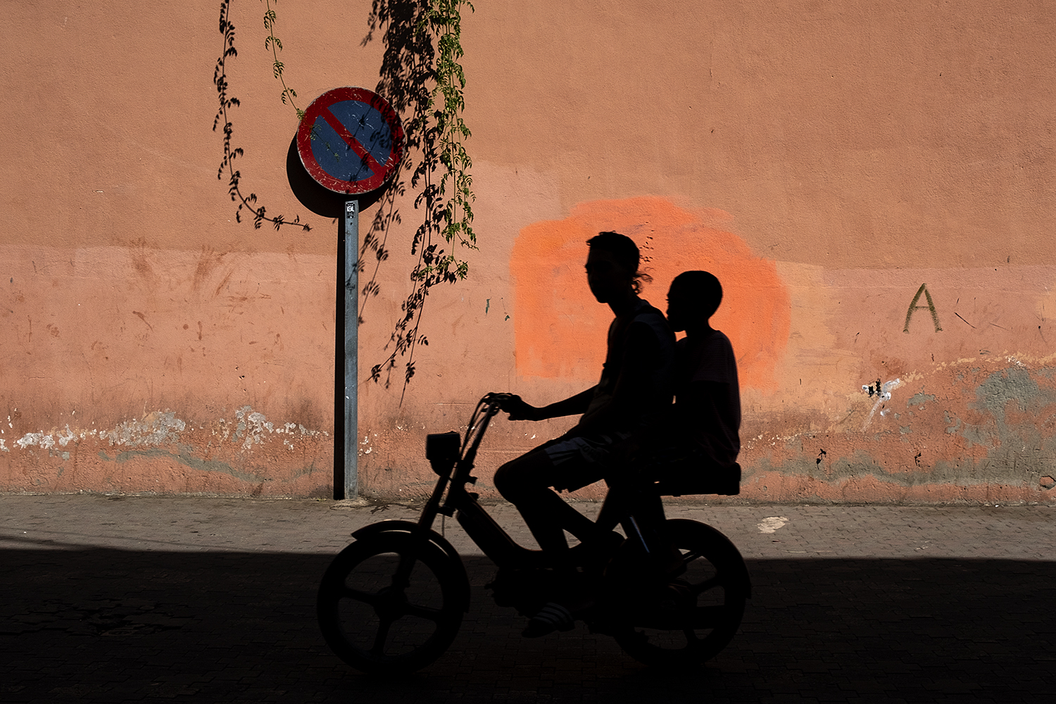 color street photography award of two boys shadow on a motorbike in Morocco by Costas Delhas - The 100 Most Inspirational Photography Quotes