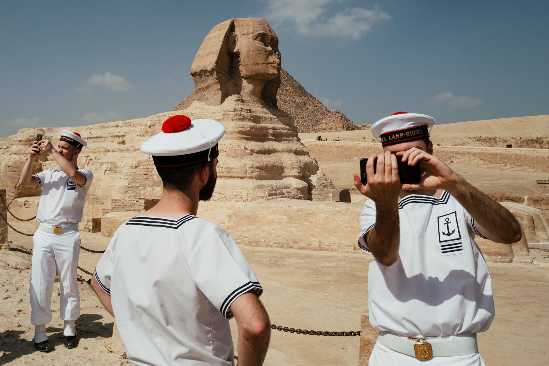 color street photography of French Navy sailors in front of the Sphinx in Egypt by Jonathan Jasberg