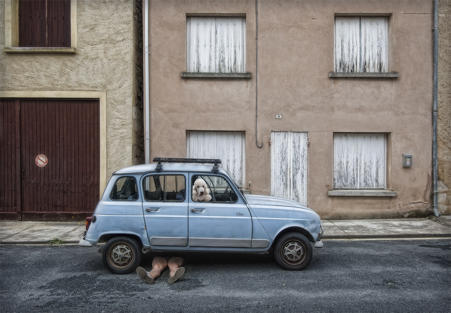 street color photograph of a car and dog shot in Dordogne, France by Marcel van Balken