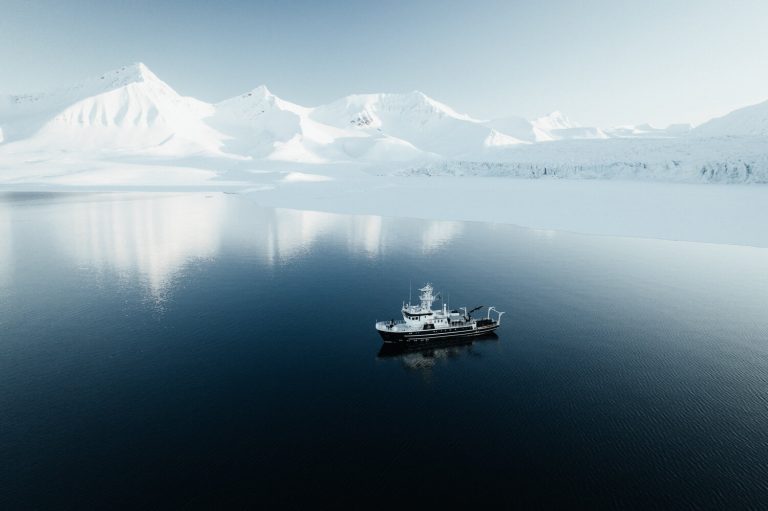 Landscape photo by Hannes Becker, glaciers, mountains, ship, fjord, Svalbard, Norway.