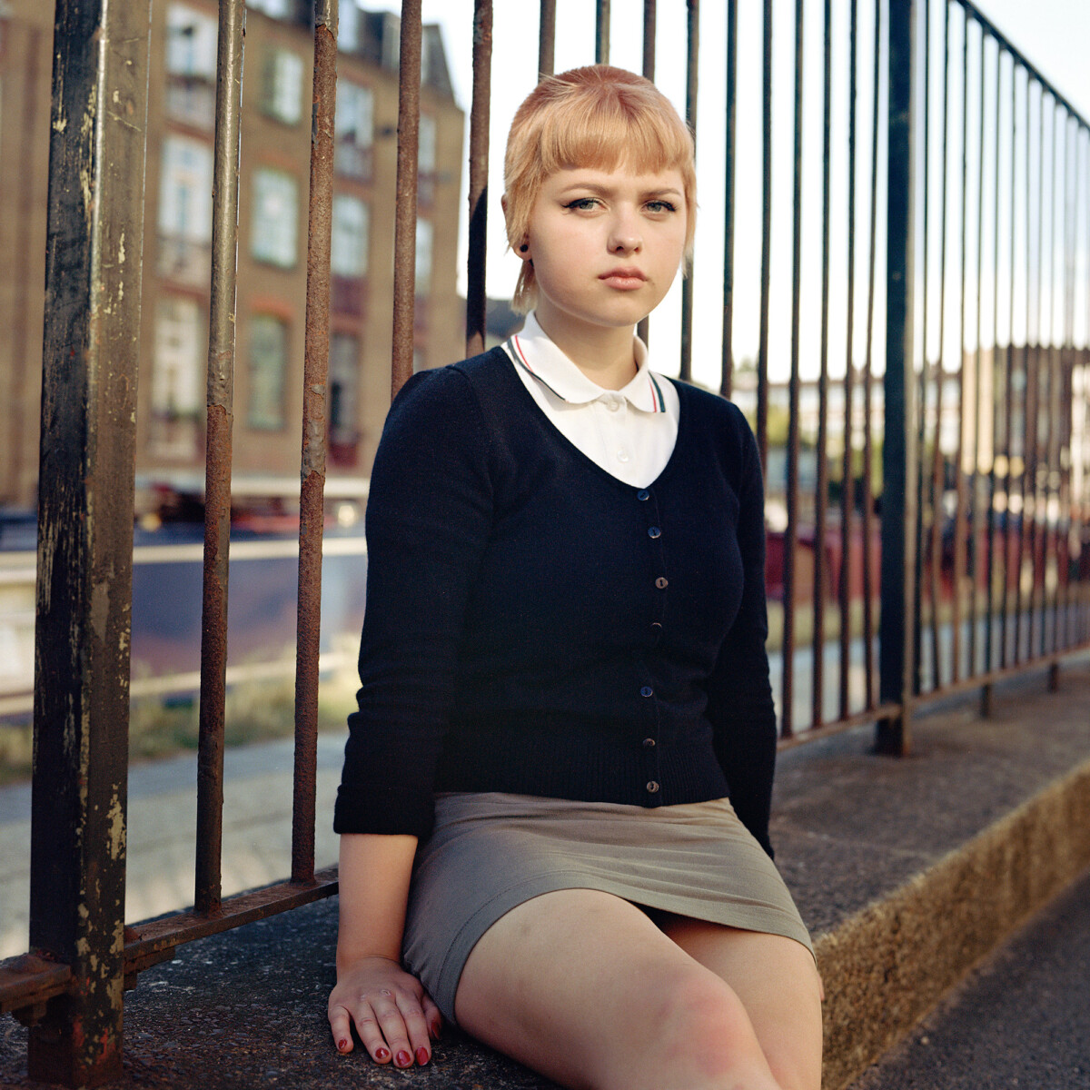 medium format analog color portrait of a skinhead girl in London, UK by Owen Harvey