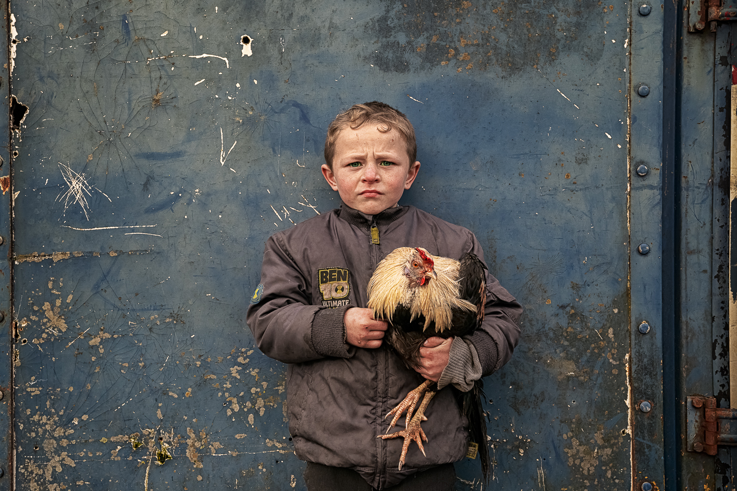 color portrait of a young Irish traveller boy and his rooster by Bob Newman