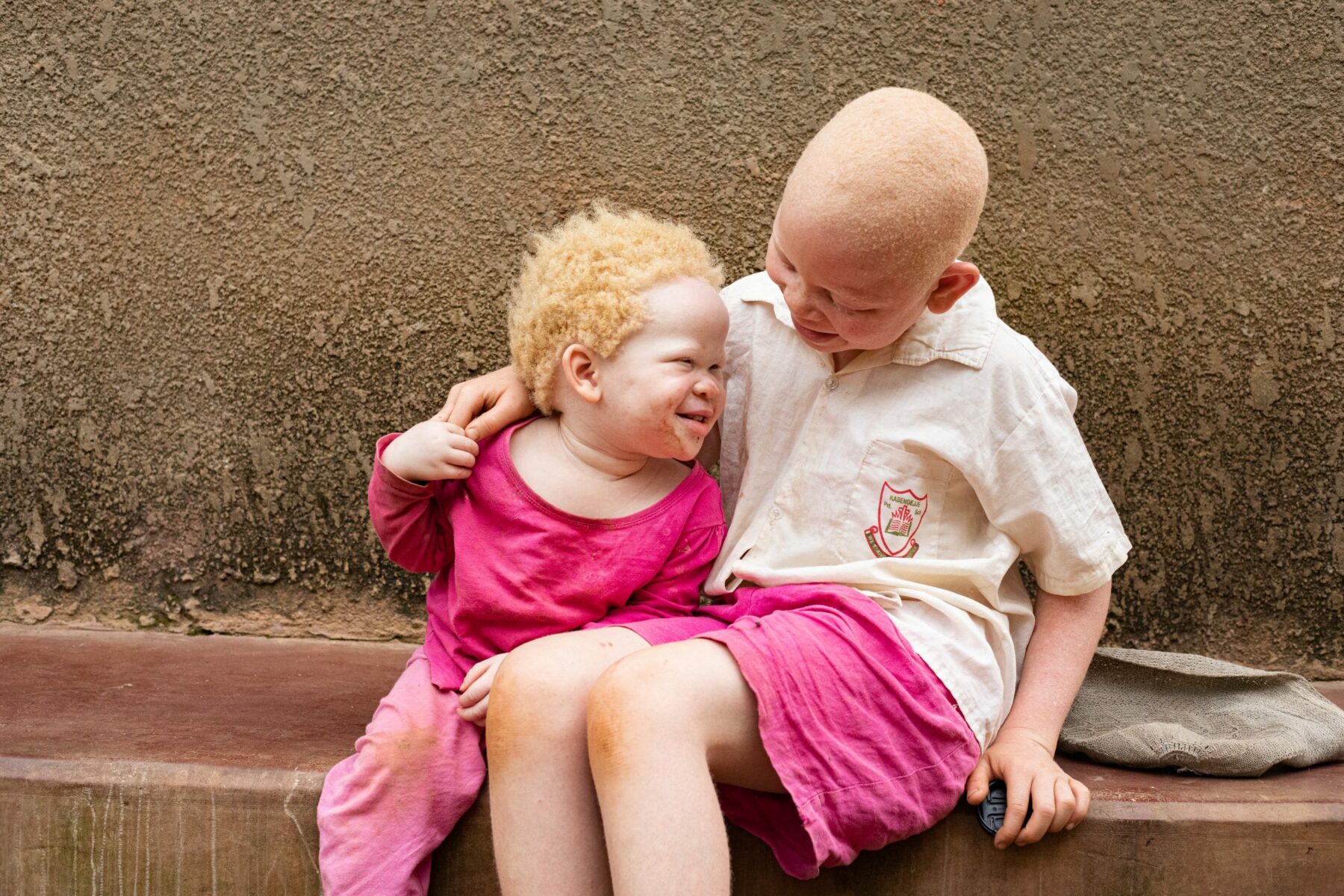 Ketra and Mary embrace while sharing a beautiful moment. Uganda. From 'Born this way' an ongoing photo series about children and women born with albinism © DeLovie Kwagala