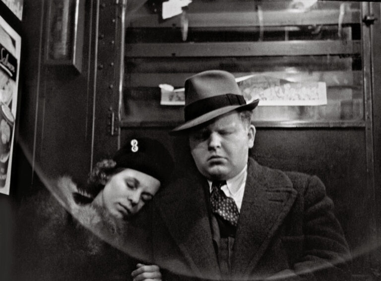 Black and White street photography by Helen Levitt, man and woman sleeping on train NYC