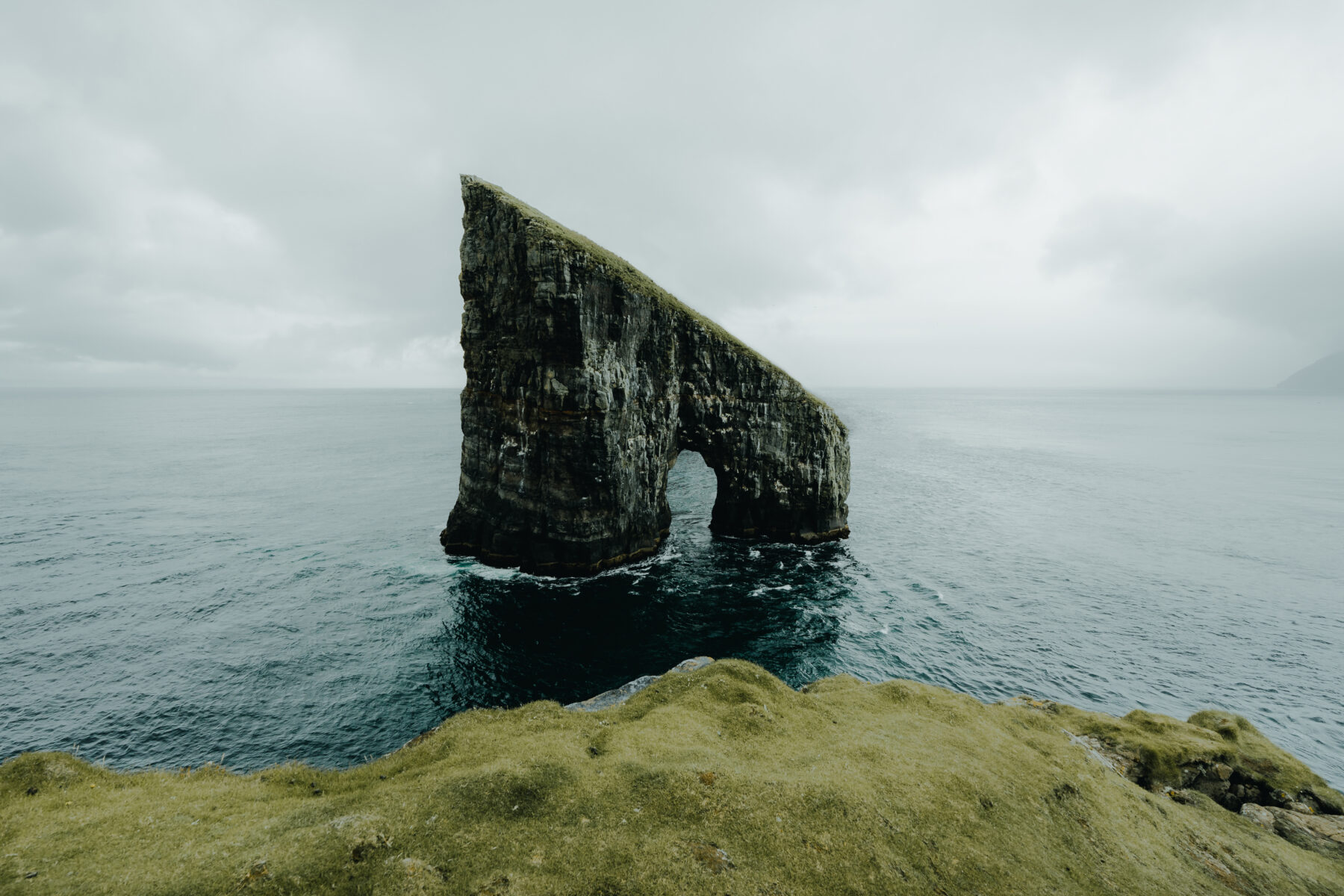 color landscape photograph of a cliff in the sea at the Faroe Islands by Paul Lichte