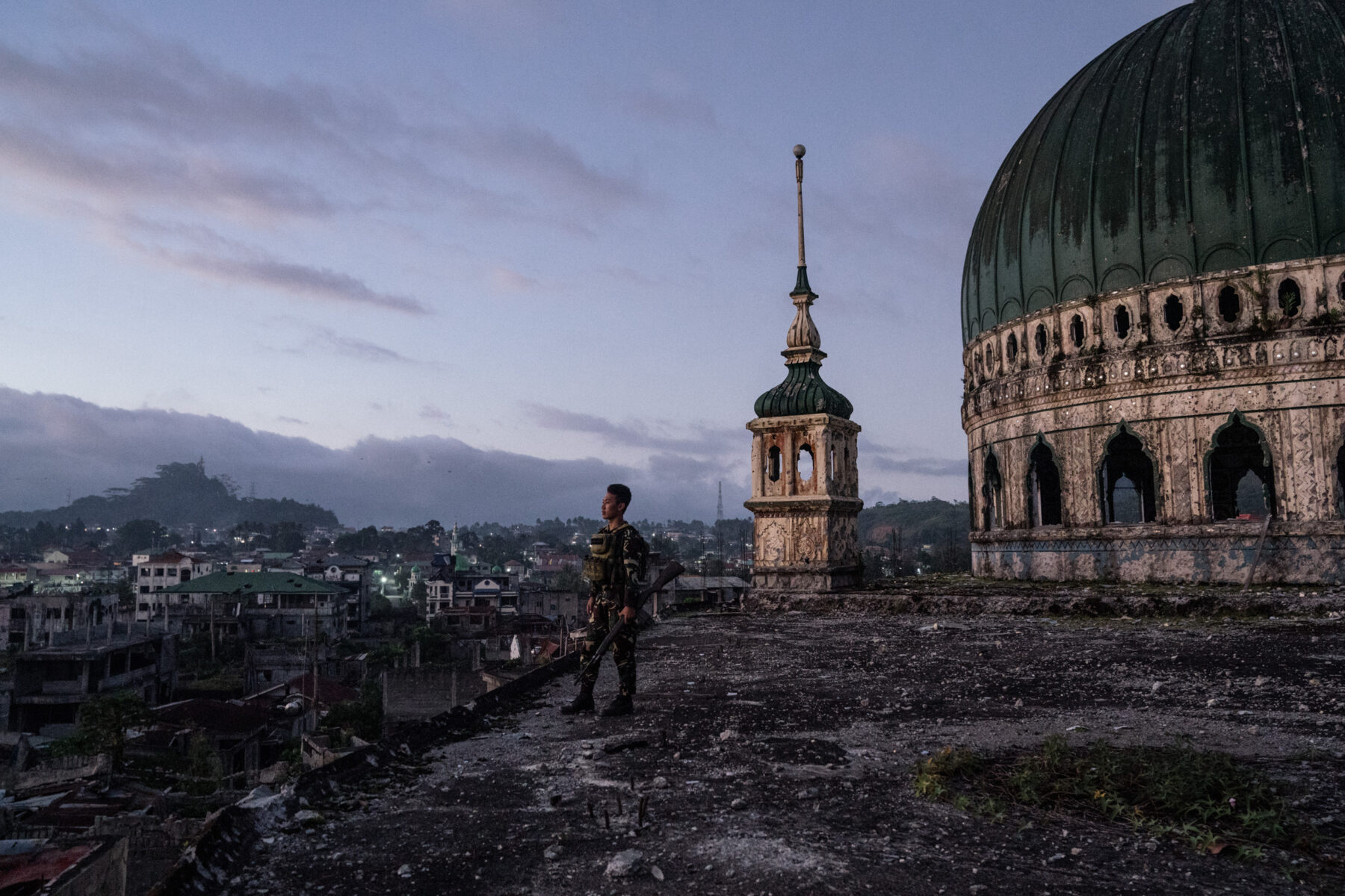 MARAWI, PHILIPPINES. JANUARY 8. A soldier is seen in the Grand Mosque, which was destroyed during the Marawi siege. Documentary photography by Hannah Reyes Morales, from the series 'Marawi'