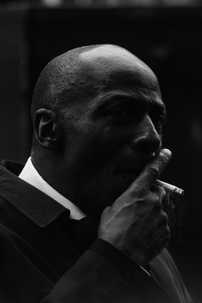 Black and white street photography by Francesco Goia, man smoking, London