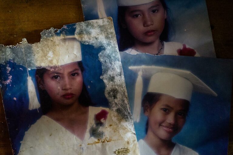 Salvaged water damaged graduation photos of Filipino sisters Jojo (left), Gemma (bottom right) and Joanne (top), in their home in the Visayas. From the series, 'Shelter From the Storm' Documentary photography by Hannah Reyes Morales