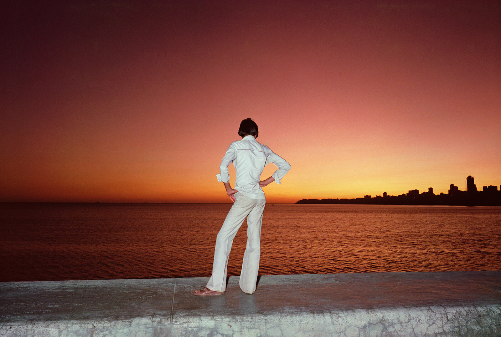 Color photography by Mitch Epstein, man overlooking the Arabian Sea, and sunset, from the Steidl book, In India