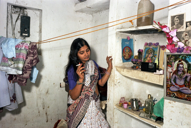 Color photo by Mitch Epstein, Rekha, Bombay 1984, woman smoking, from the Steidl book In India