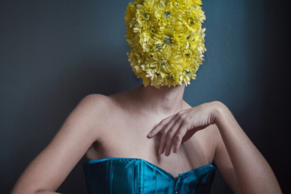 color studio portrait of a woman with flowers by Anna Karvounari