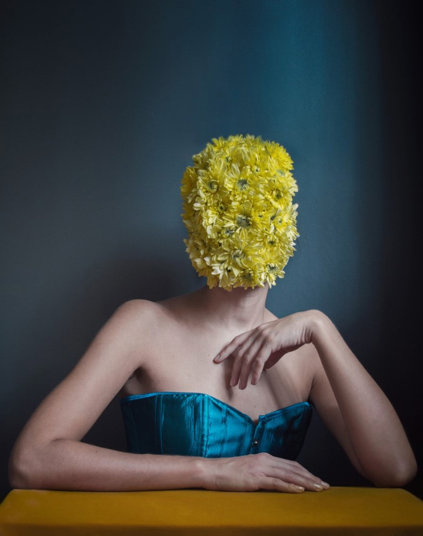 color studio portrait of a woman with flowers by Anna Karvounari