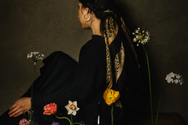 color studio portrait of a woman and flowers by Daniela Constantini