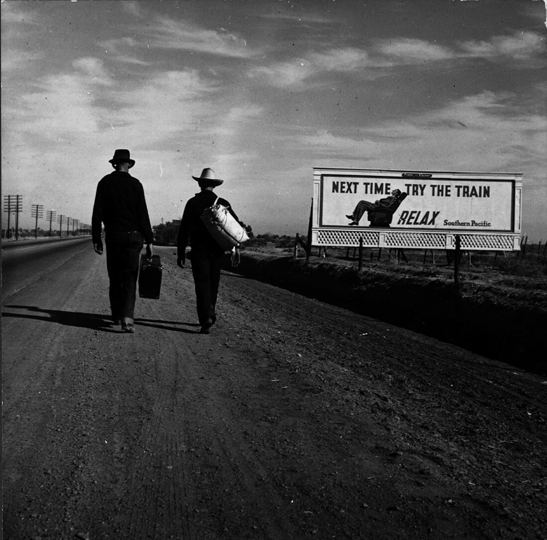 Black and white documentary photography by Dorothea Lange. two men walking towards Los Angeles 1937