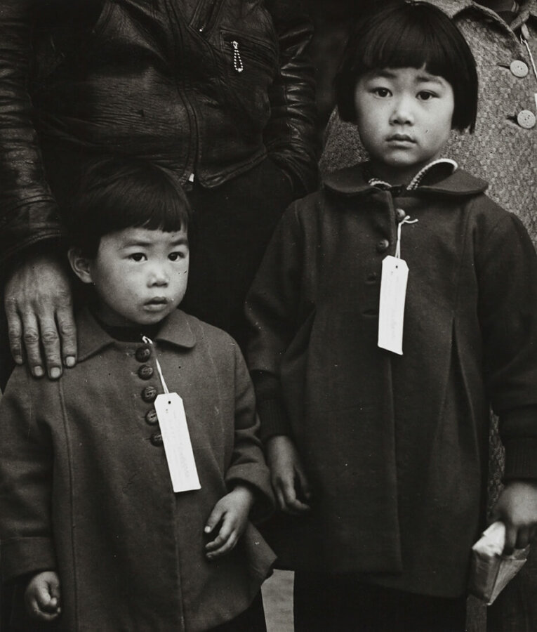 Black and white documentary photography by Dorothea Lange. Japanese Children with Tags, Hayward, California, May 8 1942