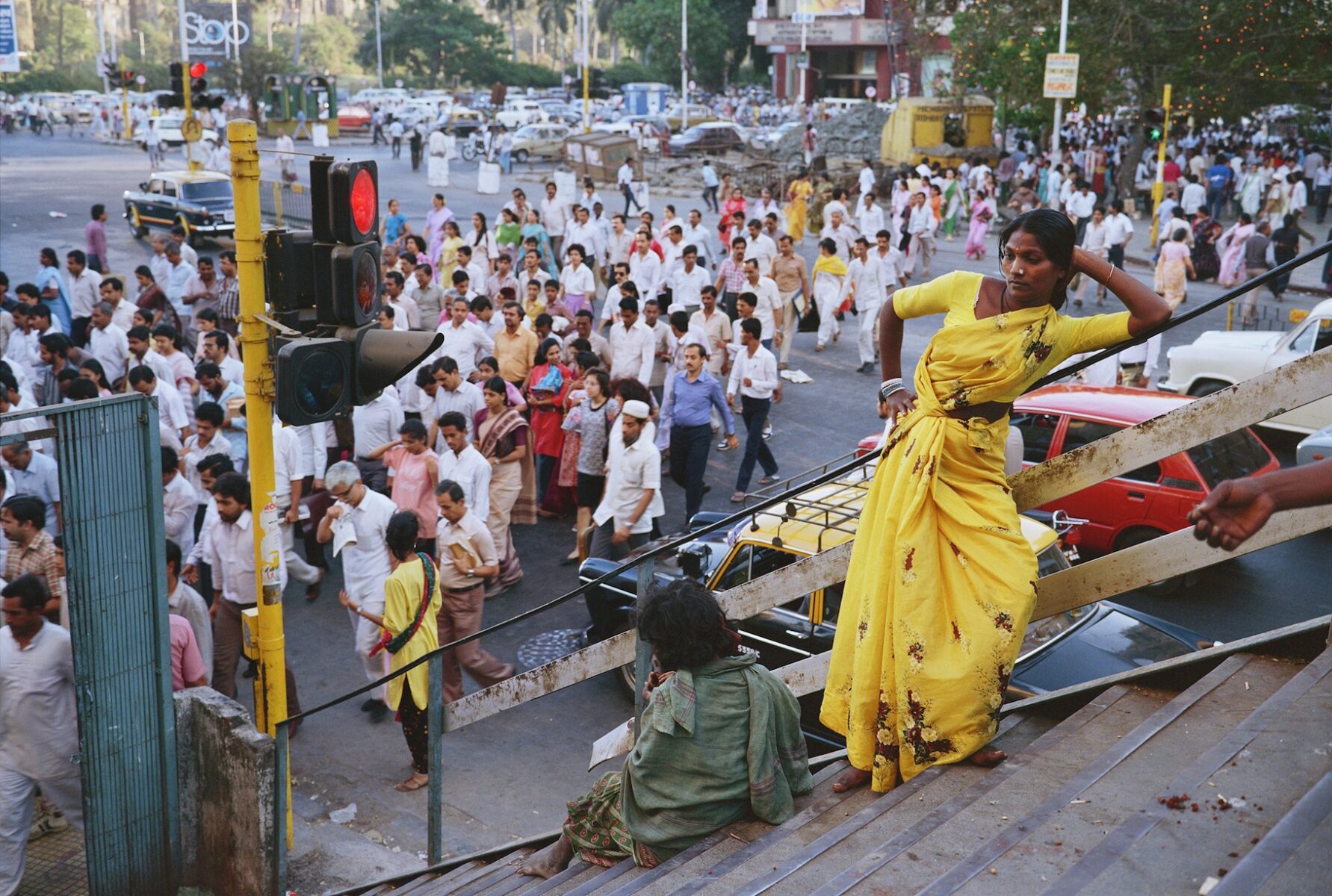 Color photography by Mitch Epstein, Churchgate Station, Bombay, Maharashtra 1989, woman in yellow dress, from the Steidl book, In India