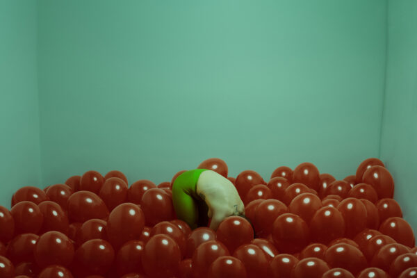 color photo of a woman with red ballons by Paolo Barretta