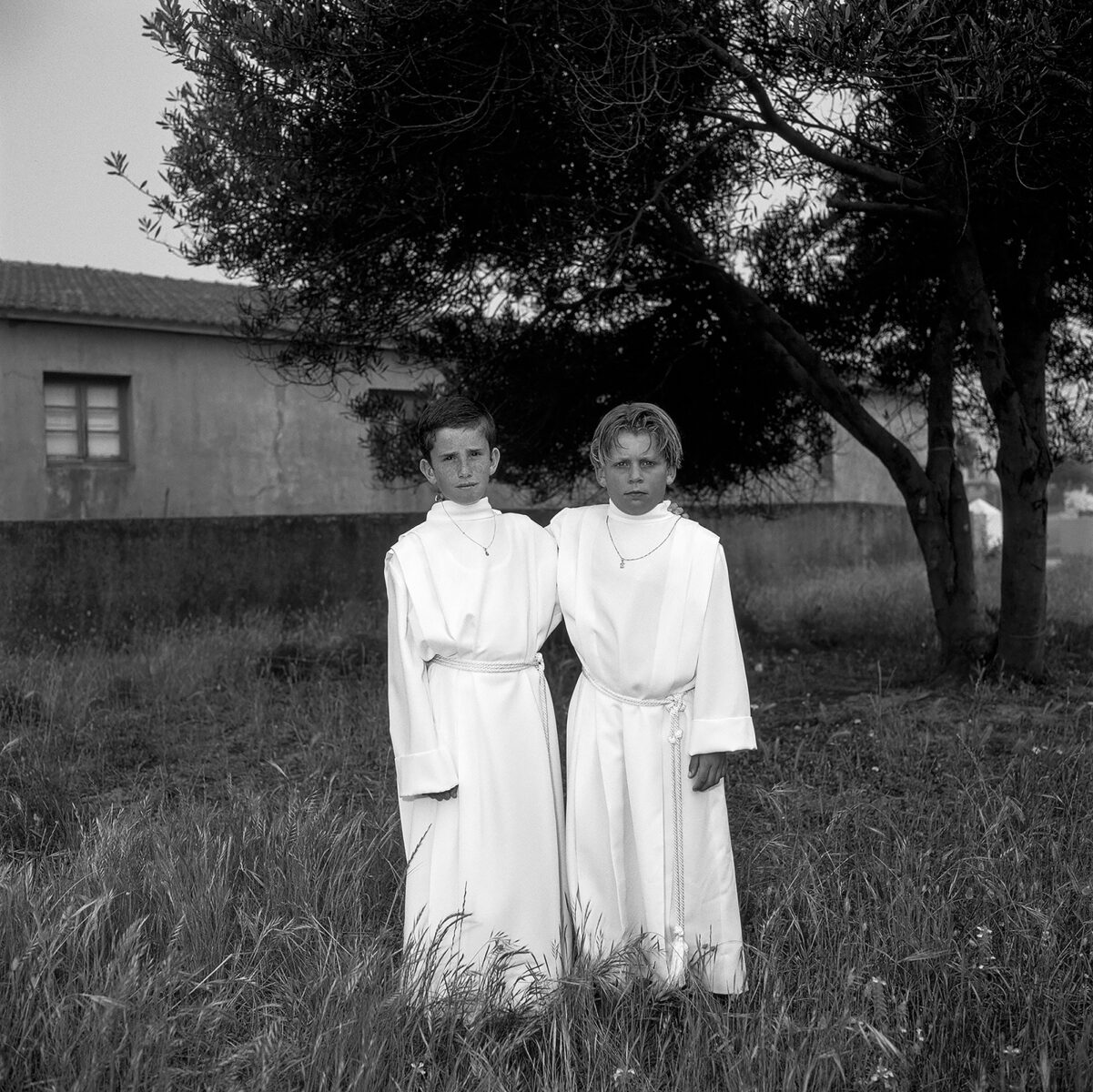 black and white film portrait of two boys on the day of their First Communion in Portugal by Candy Lopesino