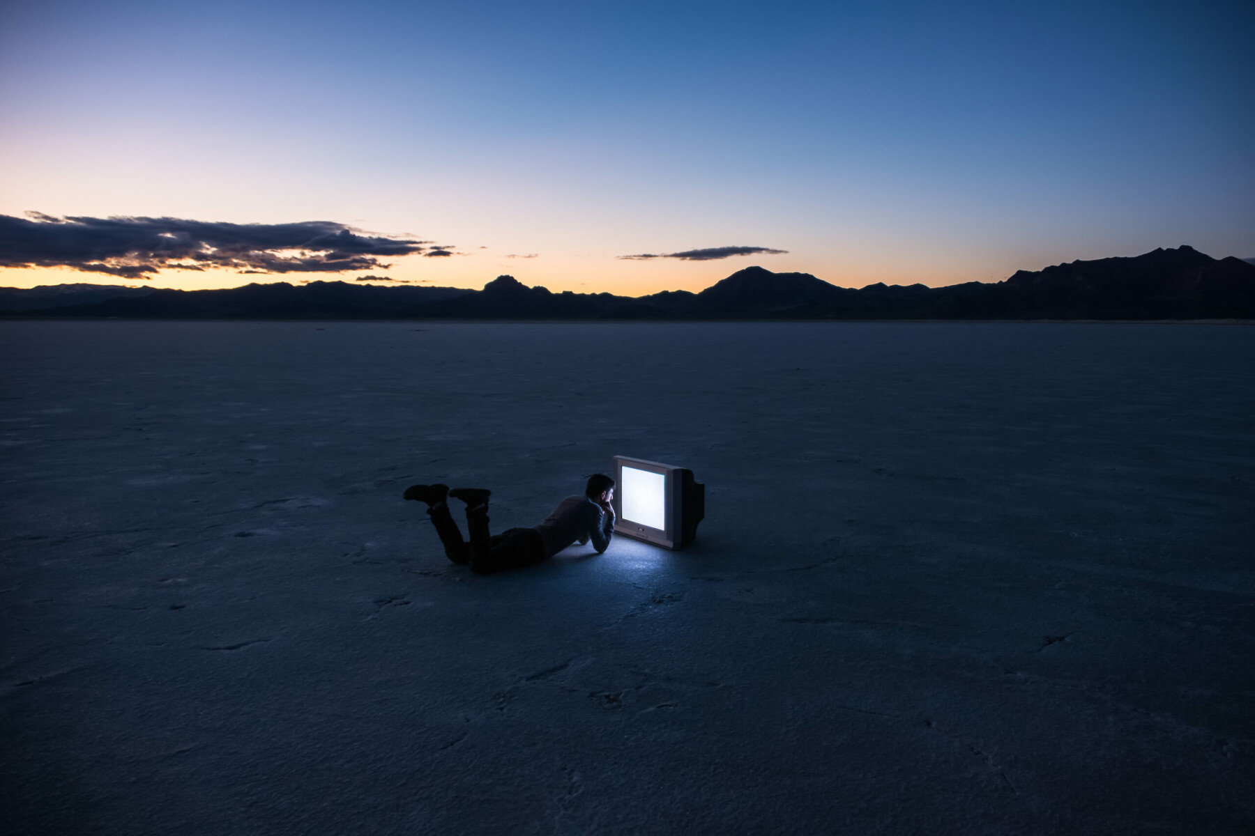 color photo of a man and tv at Bonneville Salt Flats, Utah, USA by Brian Goldfarb