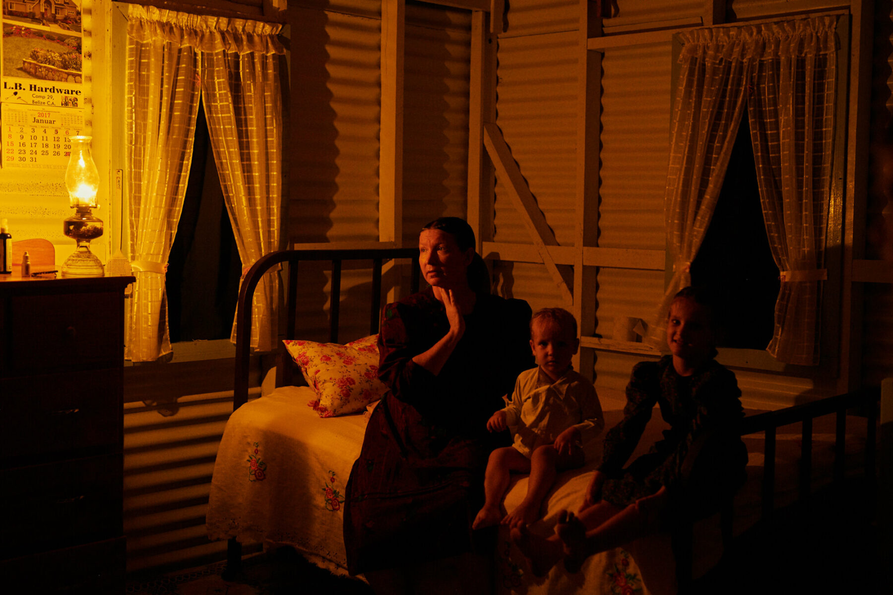 Color film photo by Jake Michaels, portrait of Mennonite womanm and children from the book c.1950