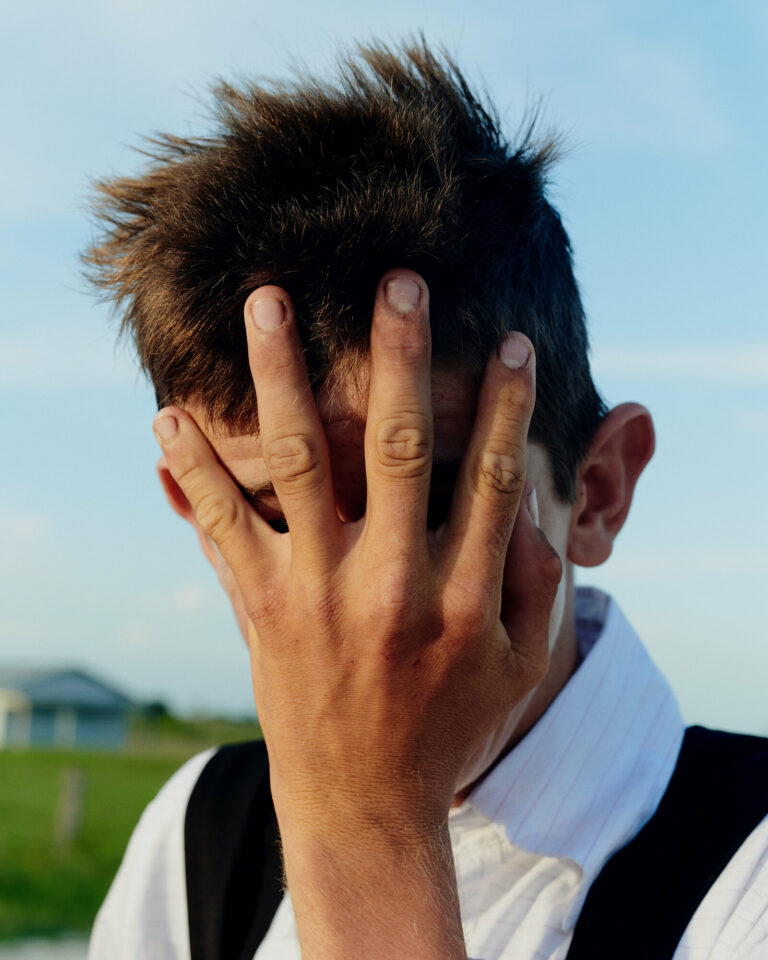 Color film photo by Jake Michaels, portrait of Mennonite boy Belize from the book c.1950