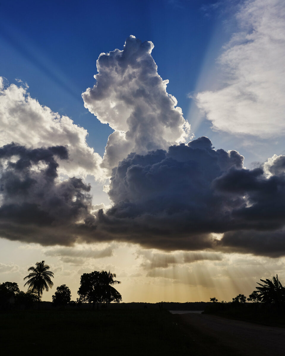 Color film photo by Jake Michaels, sky, sun, clouds Belize from the book c.1950