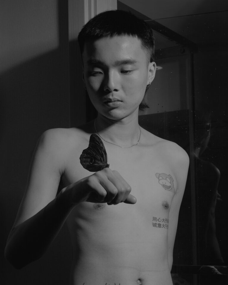 Black and white photography portrait by Bowei Yang, shirtless young man with butterfly